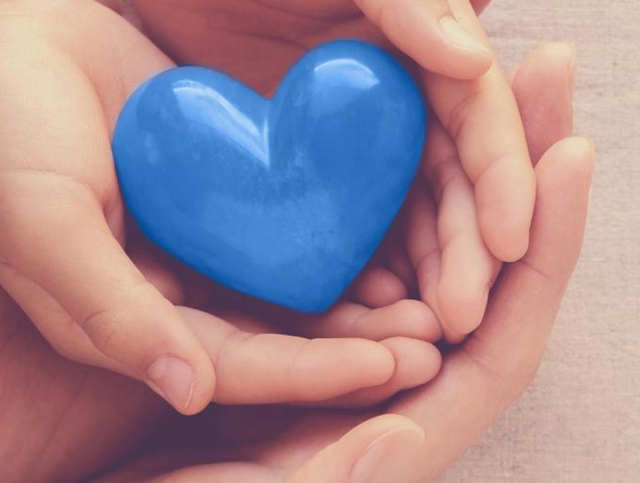 Hands holding blue heart