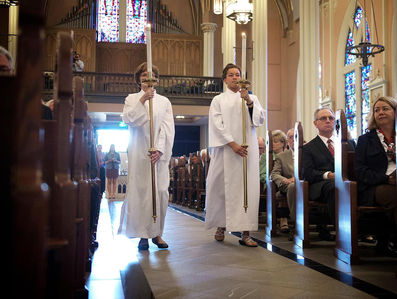 Candle bearers entering the church