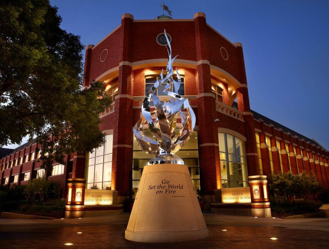 Heider-College-of-Business-flame-statue-at-night