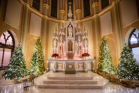 Church setting with holiday decorations.