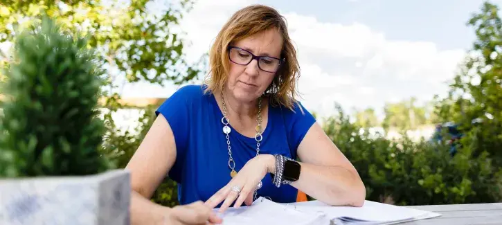 Woman working at table outside