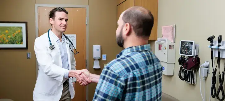 Shaking hands in doctor office.