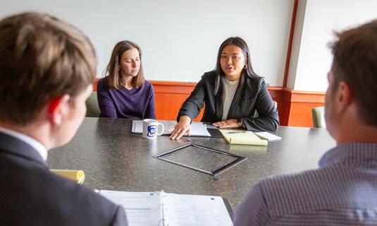 Students gathered at conference table.