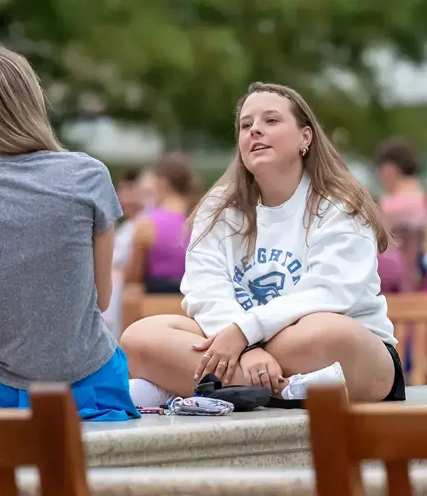Students talking on campus outdoors.