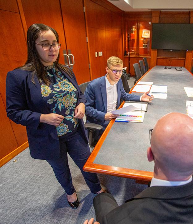 Students arguing their points at a competition.