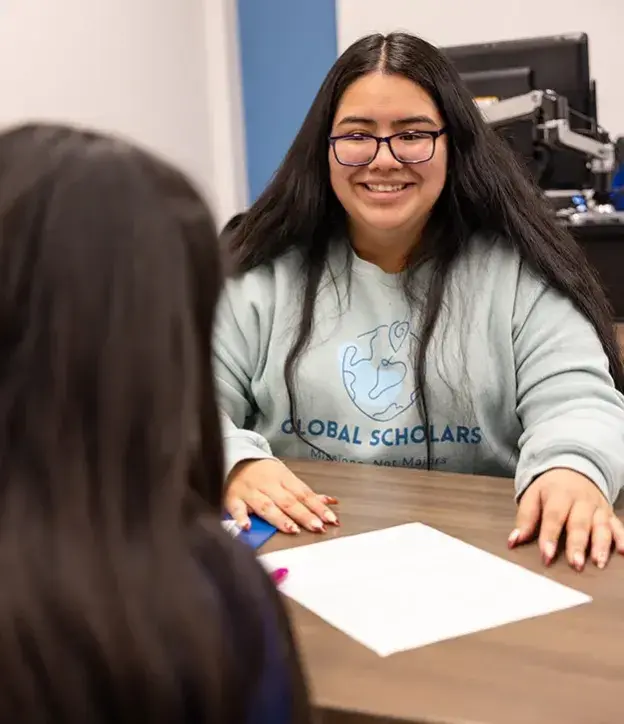 Consulting with student in office setting.
