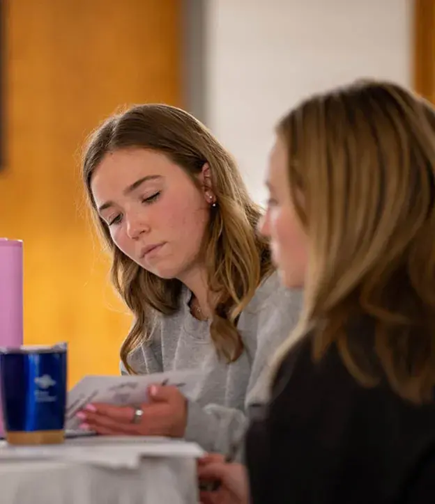 Two students studying scripture together.