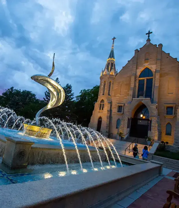 St. John's church in evening with fountain in foreground.