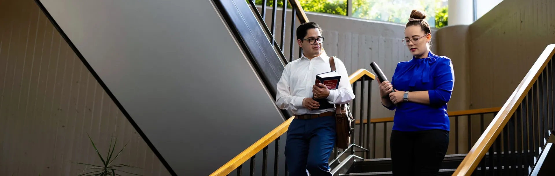 Students talking on stairwell.