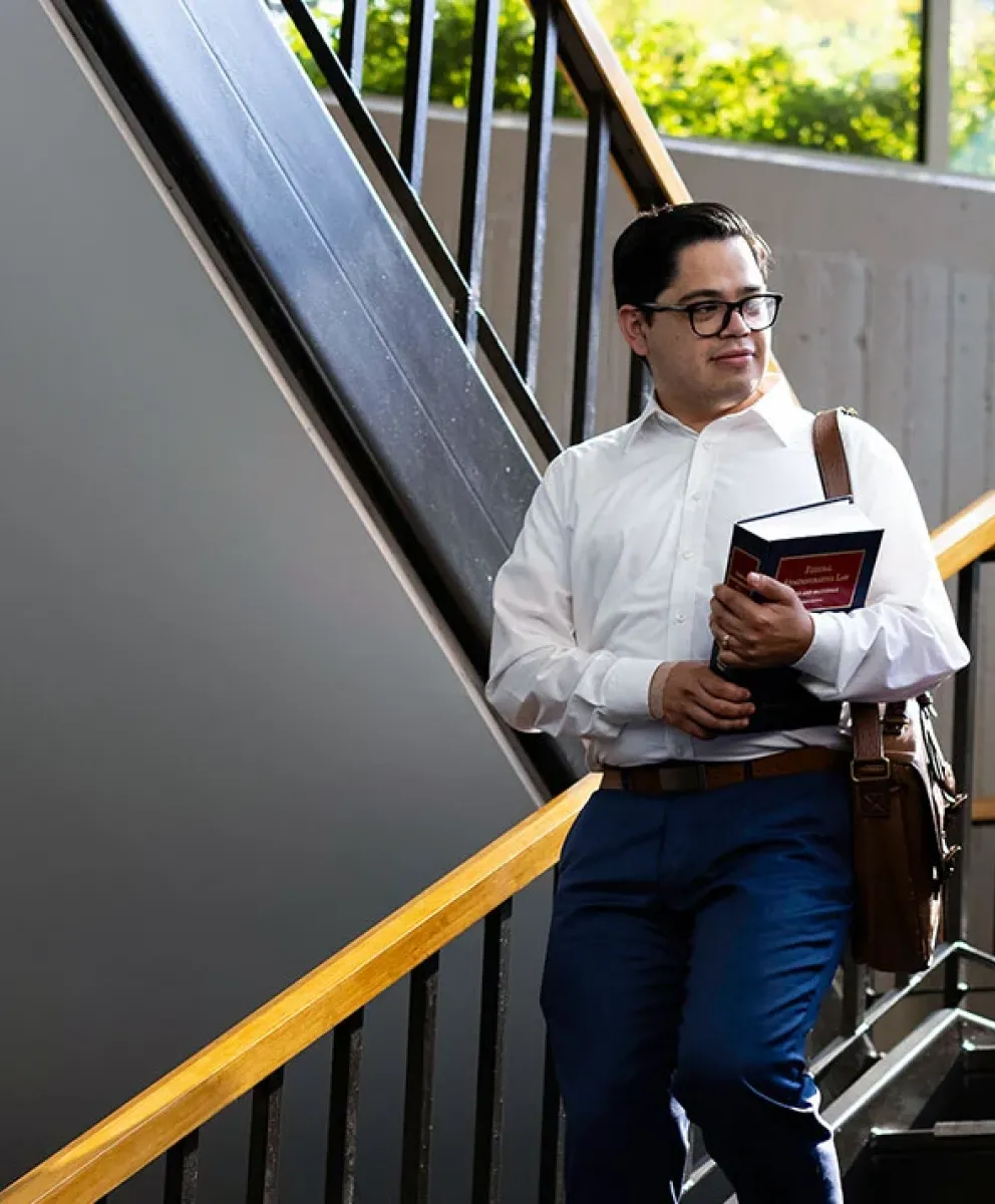 Students talking on stairwell.