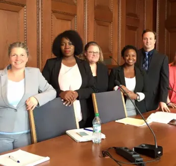 Students assembled in courtroom setting for photo.