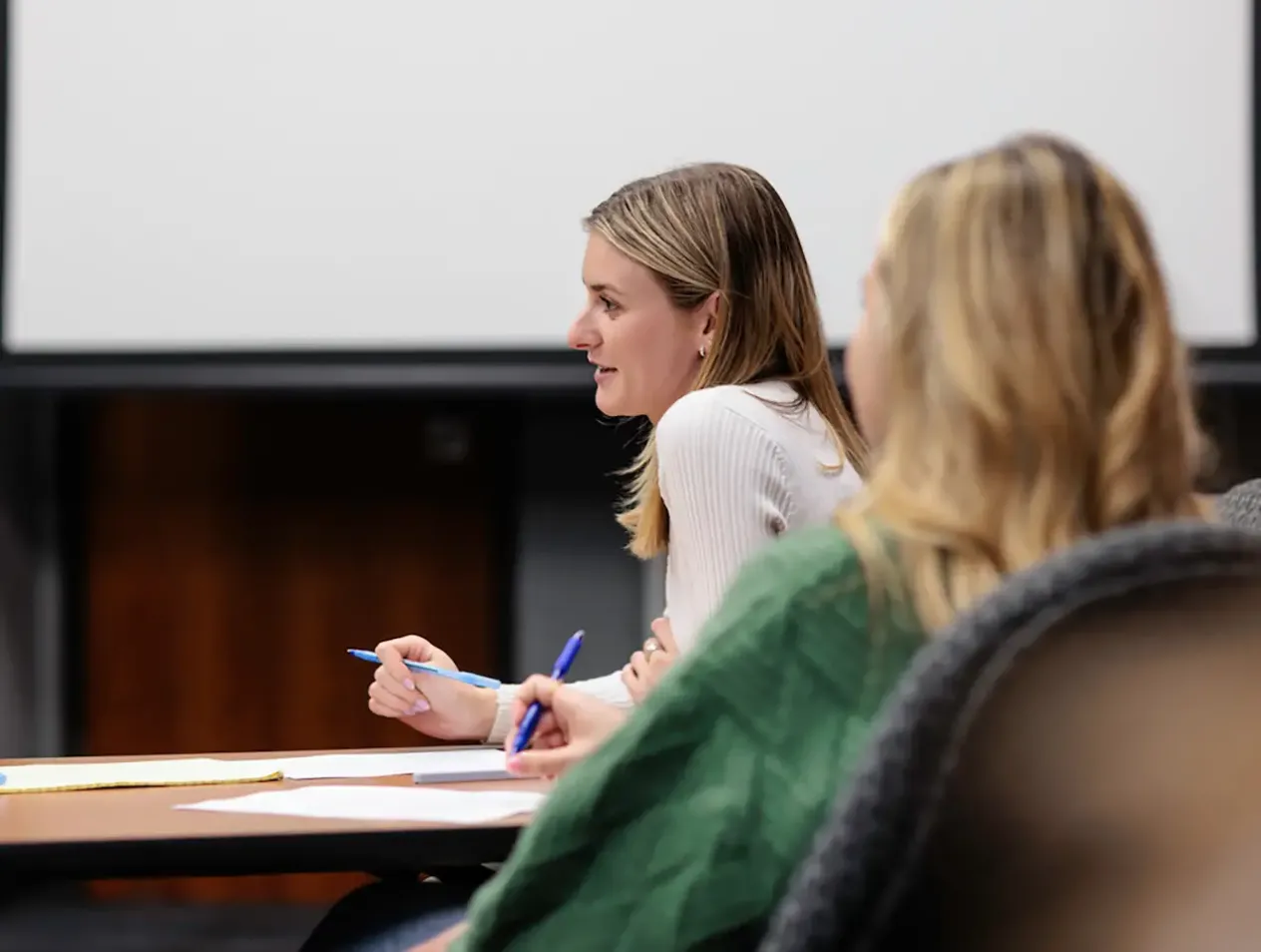 Students taking notes in class.