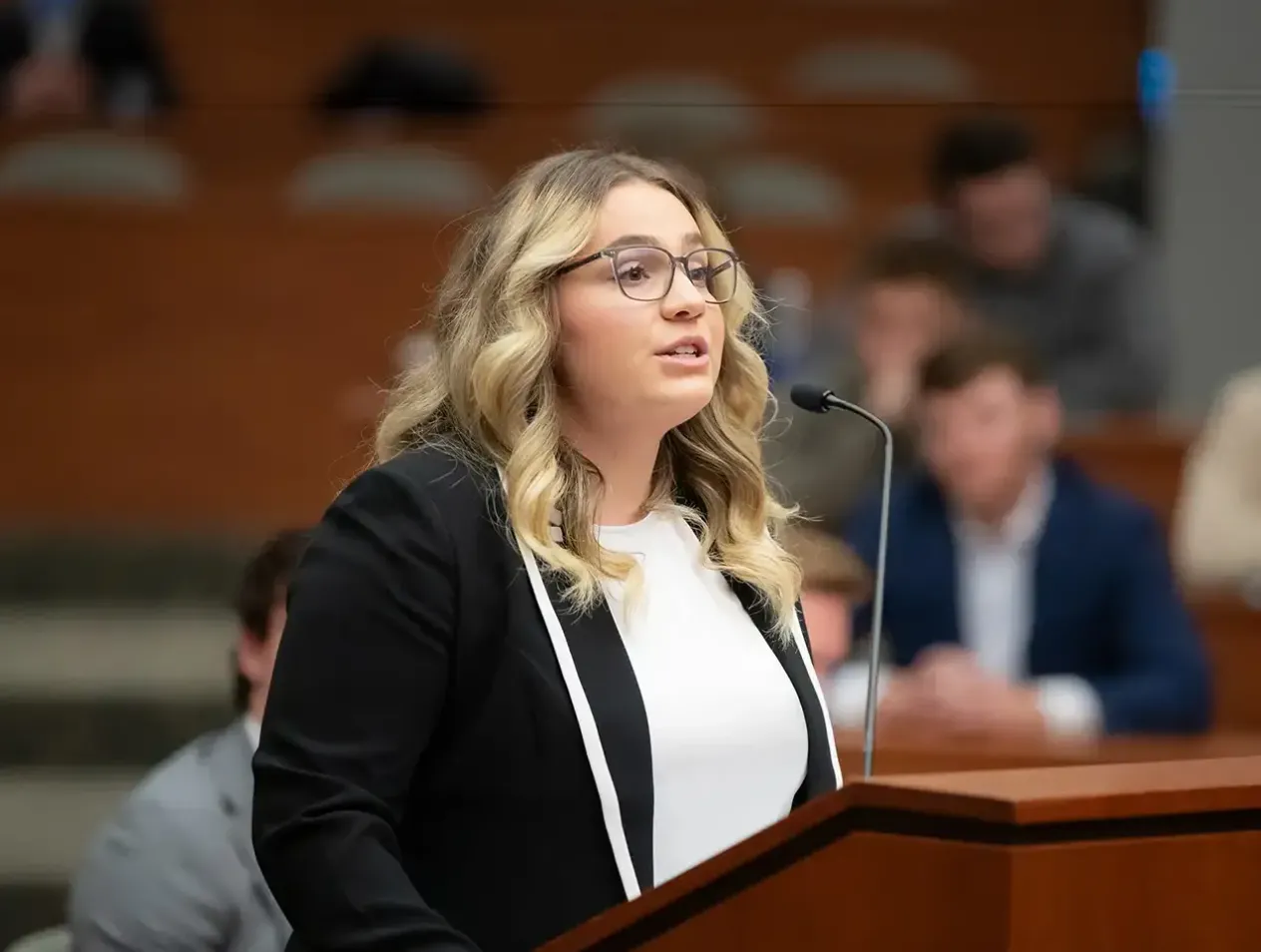 Law student speaking at courtroom podium