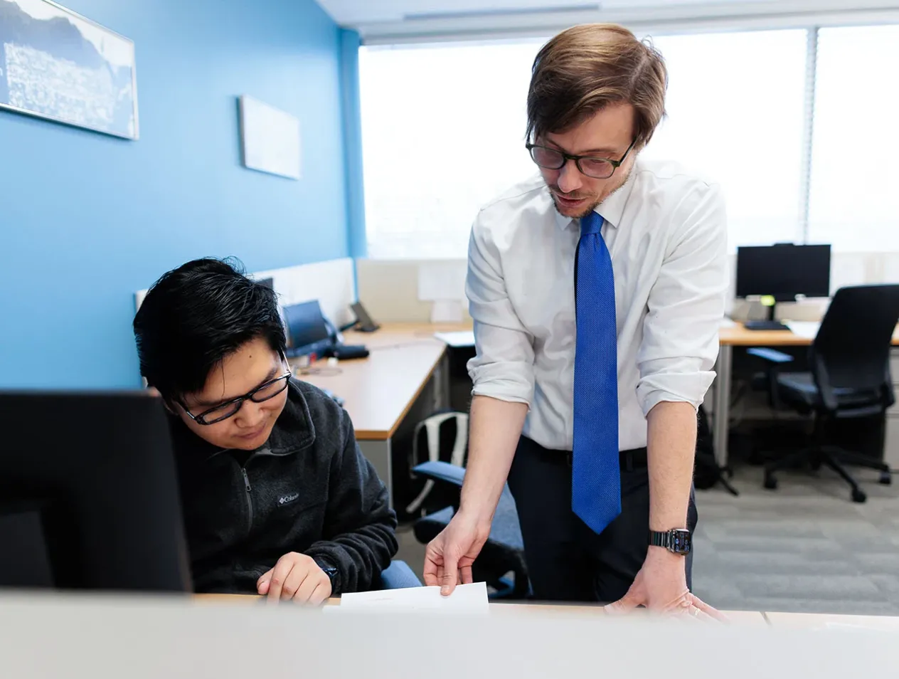 Professor consulting with student on paper.