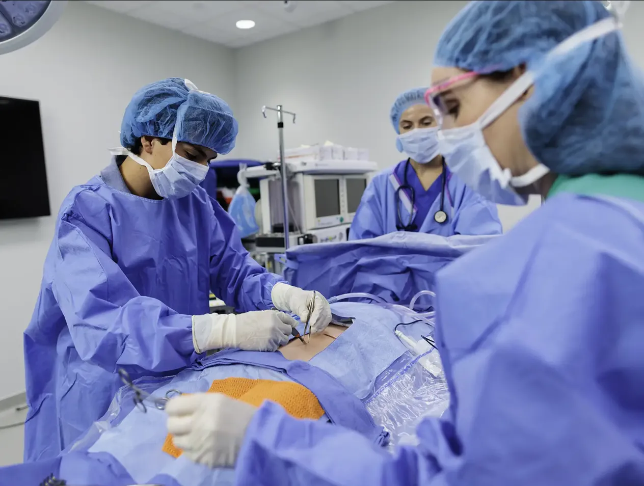 Surgeons in the operating room in blue scrubs