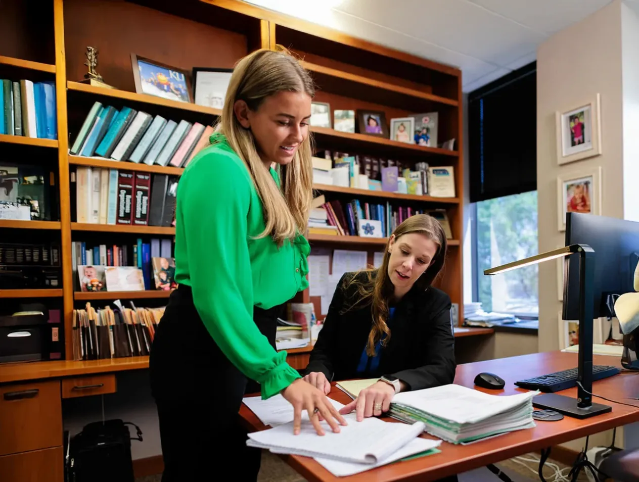 Law student and faculty collaborating in office