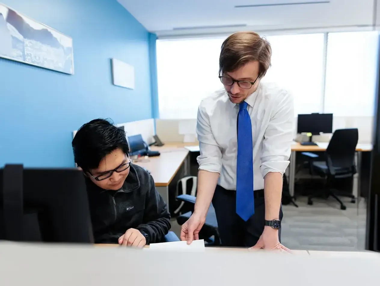 Two young men exploring law paper.