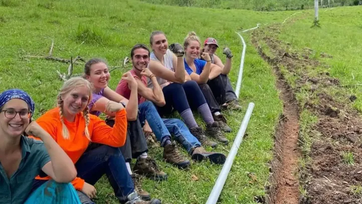 Isabella Brown with students working on pipe project in Dominican Republic.