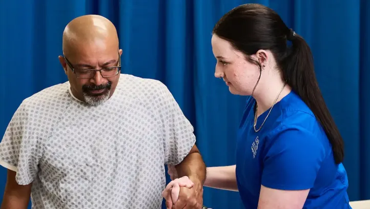 Nursing student assisting patient