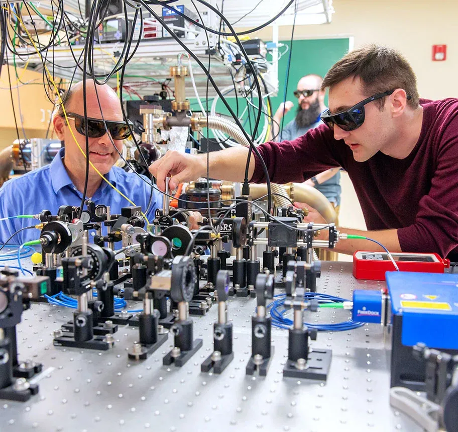 Physics lab student and faculty