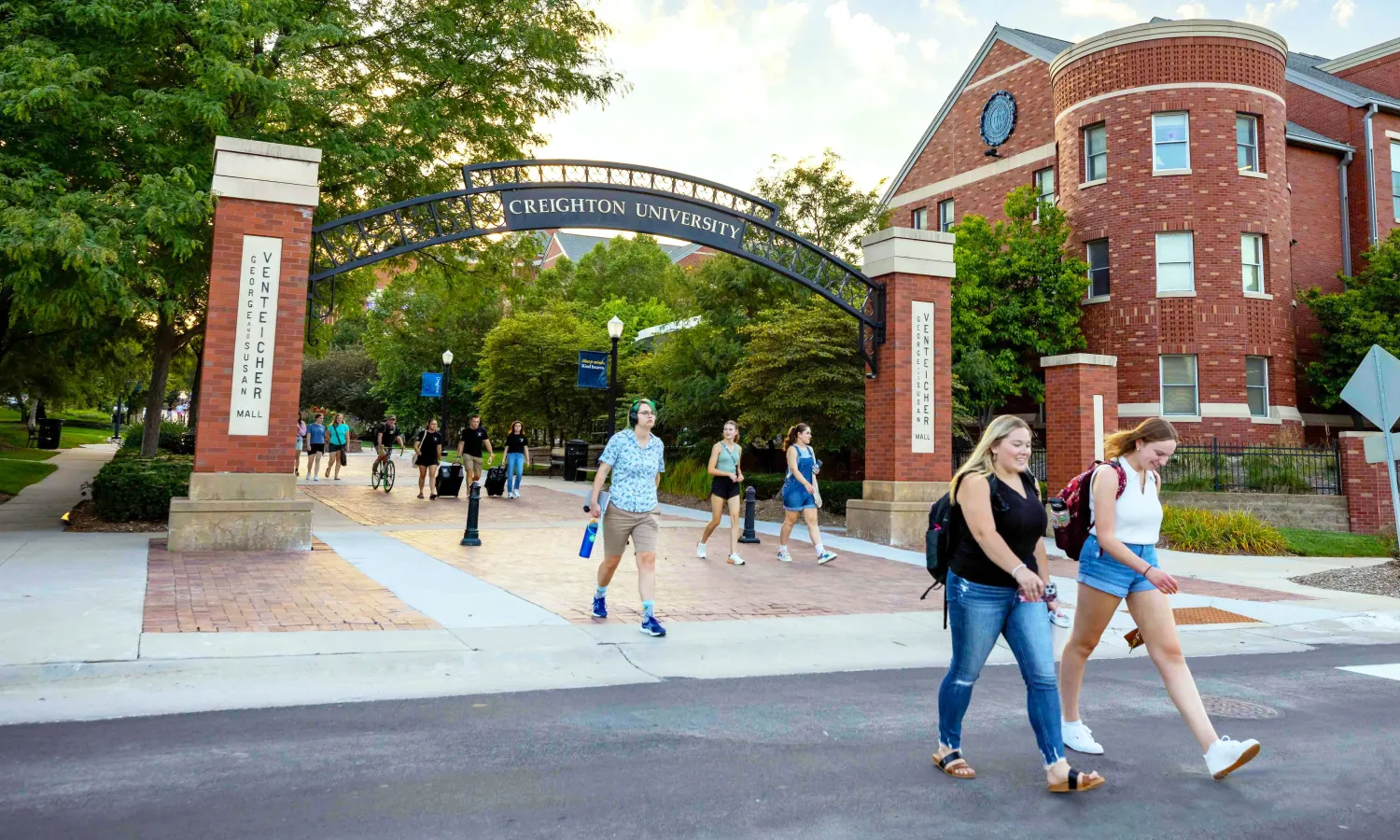 Homepage Hero Image of students walking under Creighton arch