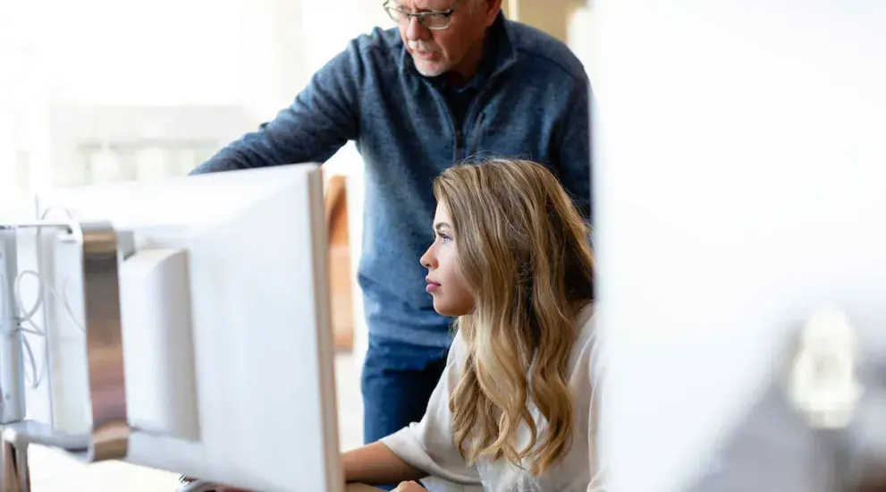 Professor showing student something on the computer