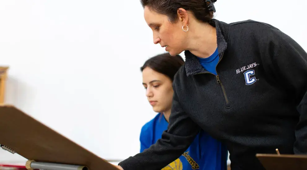 Professor pointing to student drawing