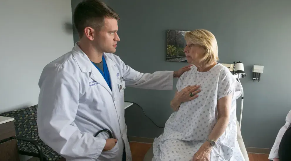 Doctor speaking with patient in examination room