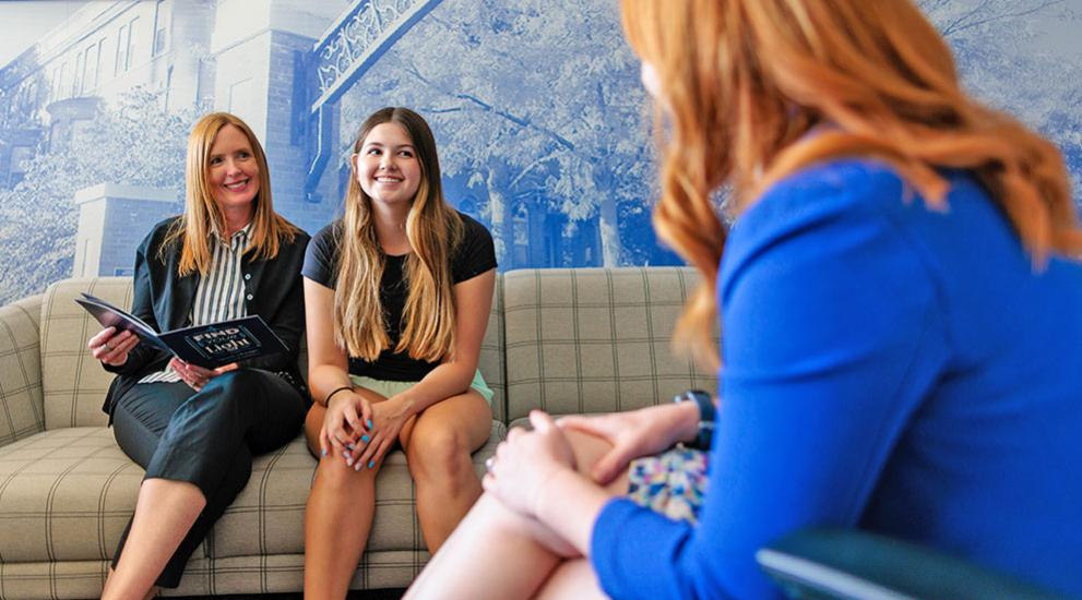 Mother and daughter meeting with admissions counselor