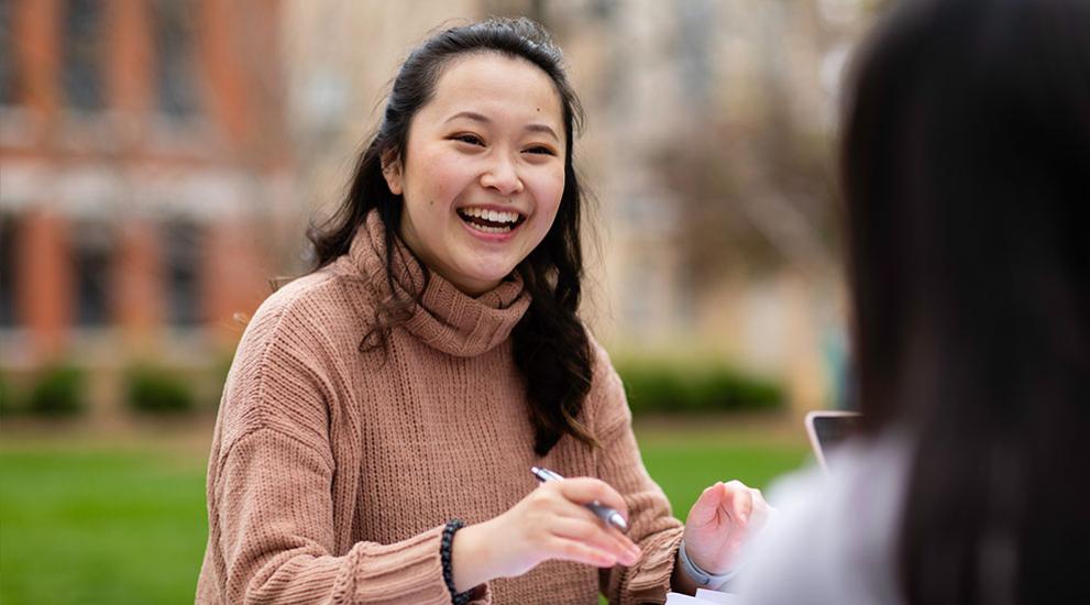 Students outdoors smiling