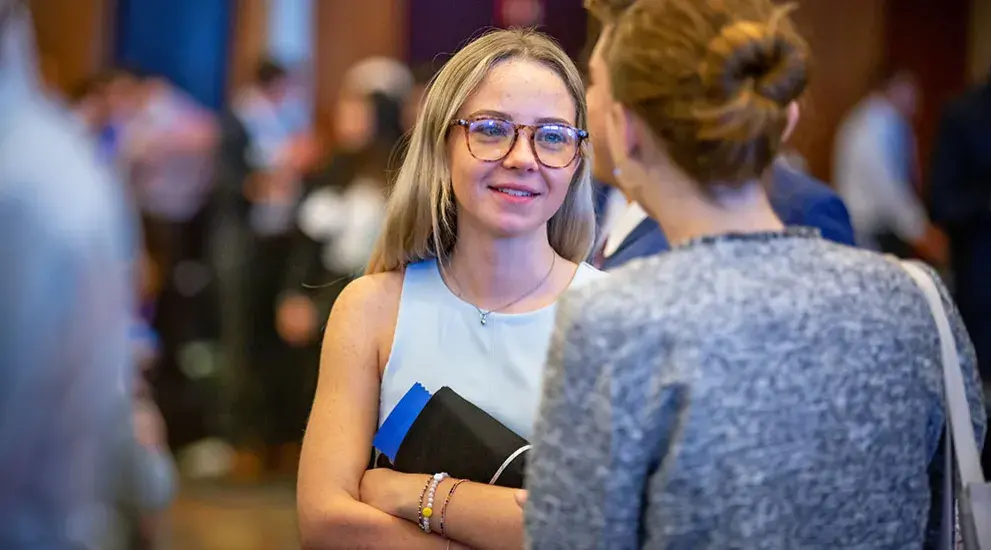 Student talking to college rep at admissions event