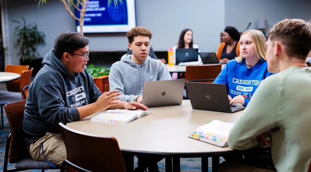 Students studying together at table.