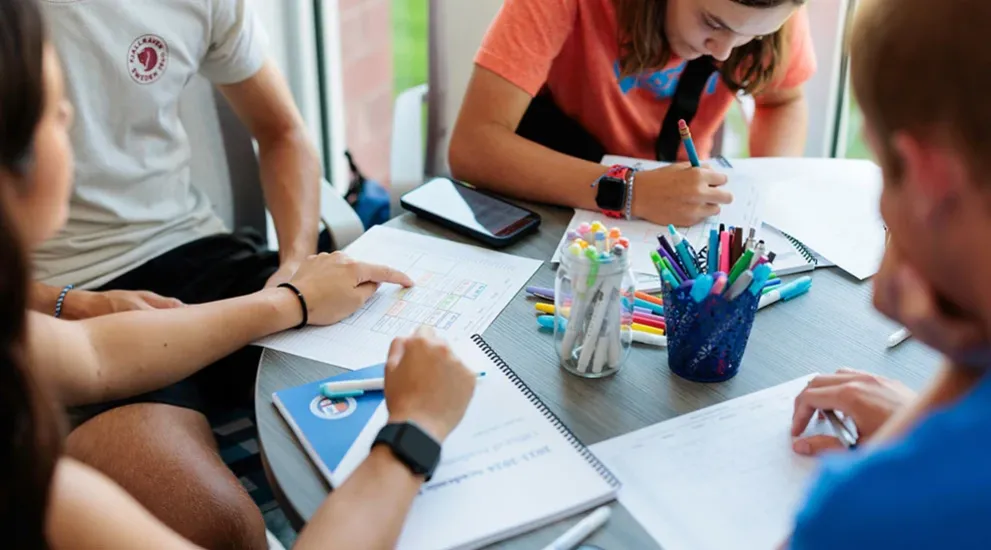 Students working at table.