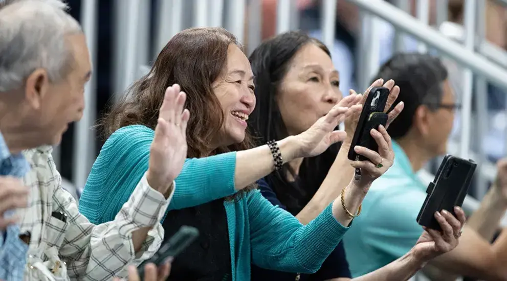 Parents taking pictures on campus.