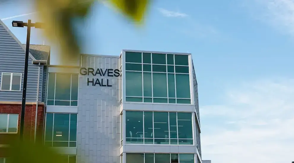Graves Hall exterior with blue skies and white clouds.
